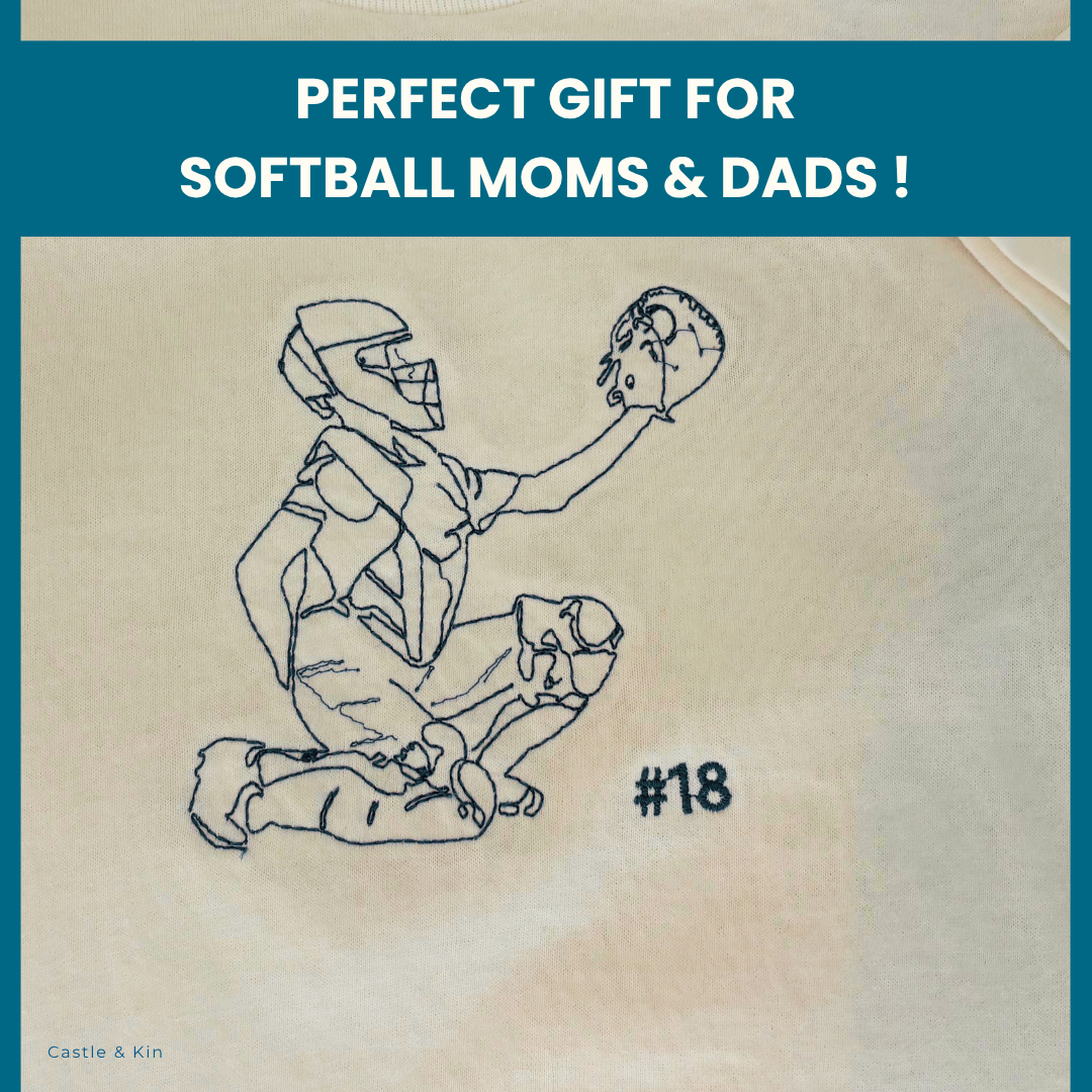 Embroidered outlined design of a softball girl player on a white tee shirt with text 'Perfect Gift for Softball Moms & Dads!'